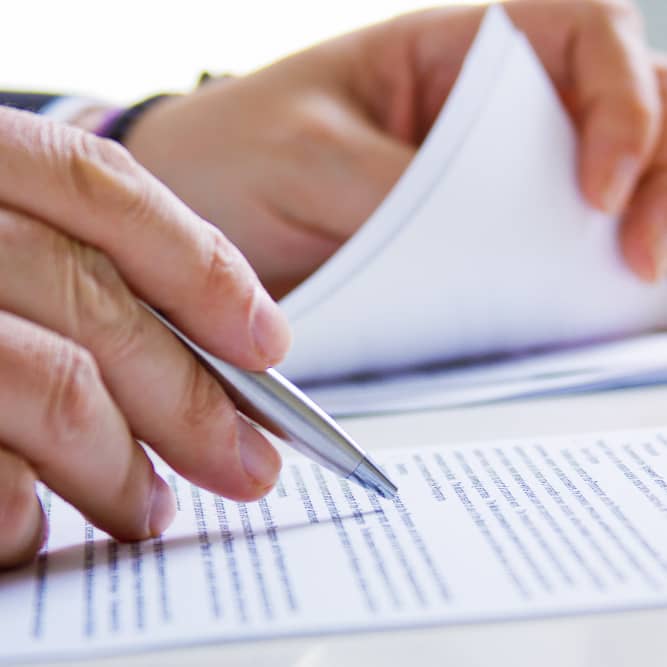 Main signant un document juridique dans le cadre d’un litige entre associés de SCI